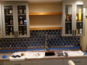 Kitchen cabinets filled with bottles of liquor